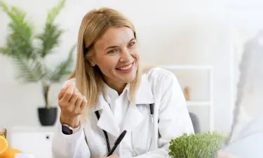 Wisconsin family nurse practitioner smiling with pediatric patient during appointment